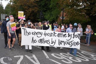 People take part in a Stand Up To Racism rally outside the Sheraton Four Points Hotel in Horley